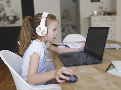 girl at computer engaged with online learning from home